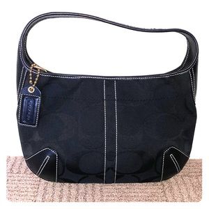 Black shoulder bag with classic Coach pattern.